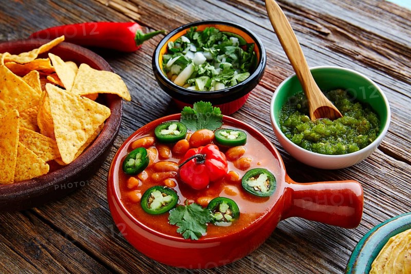 Frijoles charros mexican beans with chili pepper sides and tortillas