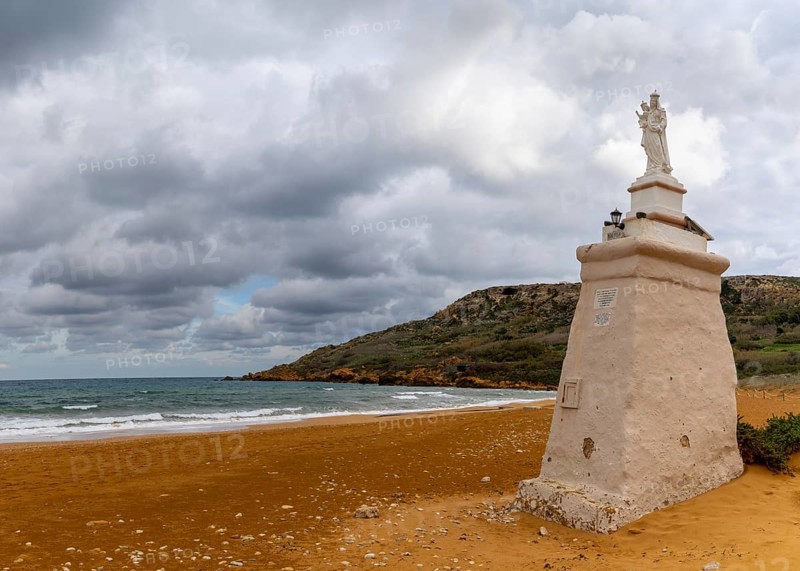 Ramla Bay, Malta, 20 December, 2023: view of the red sand beach and Staue of Our Lady in Ramla Bay on Gozo Island in Malta, Europe