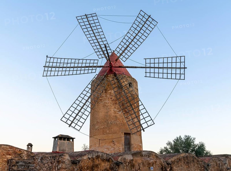 Algaida, Spain, 21 January, 2024: historic windmill in the country town of Algaida in the interior of Mallorca at sunrise, Europe