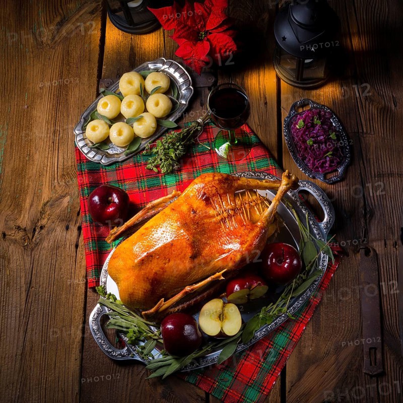 Festive stuffed roast goose with red cabbage and dumplings