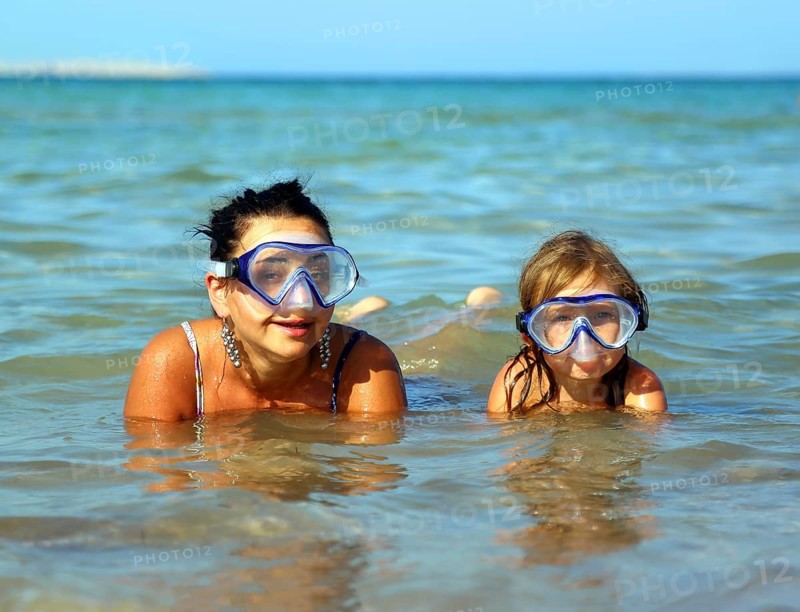 Happy summer vacation, snorkeling daughter with mother