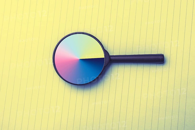 Looking through a magnifying glass to documents. Concept of search