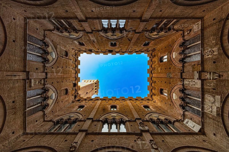 View into the sky of the Torre del Mangia, through a historic courtyard, Palazzo Pubblico, Siena, Tuscany, Italy, Europe