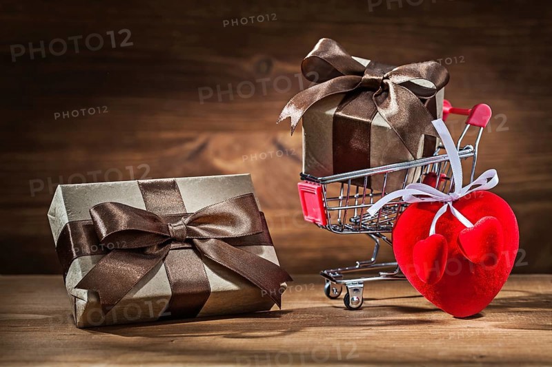 Two vintage gift boxes in shopping cart and heart toy