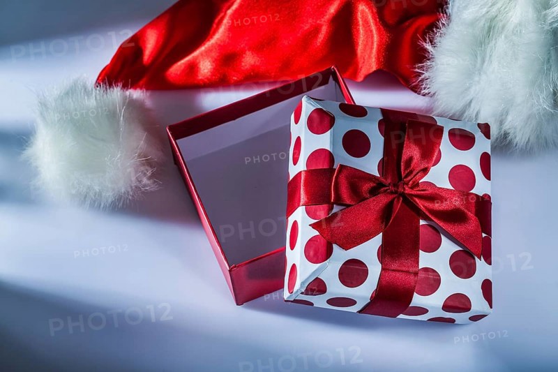 Santa hat wrapped gift box on white background