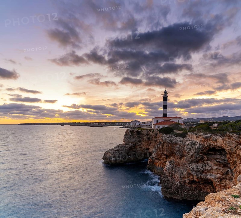 A view of the Portocolom Lighthouse in eastern Mallorca at sunset