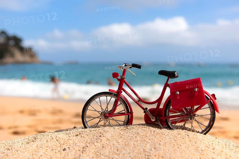 Red female bike at the beach
