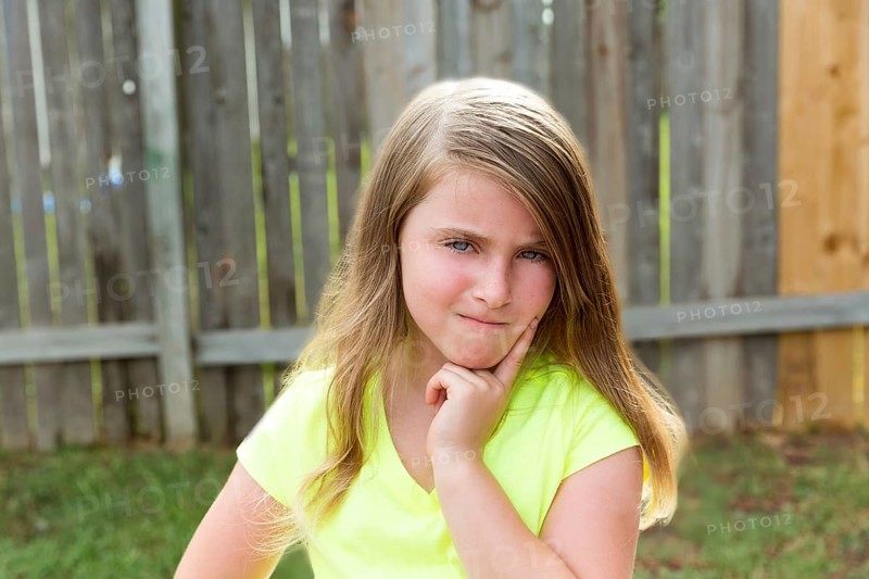 Kid girl with disappoint expression finger thinking expression outdoor