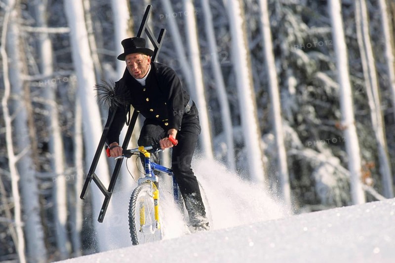 Chimney sweep on a mountain bike in winter, chimney sweep, chimney sweep