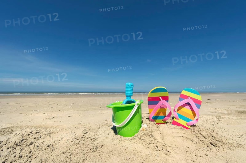 Summer beach with toys and flip flops