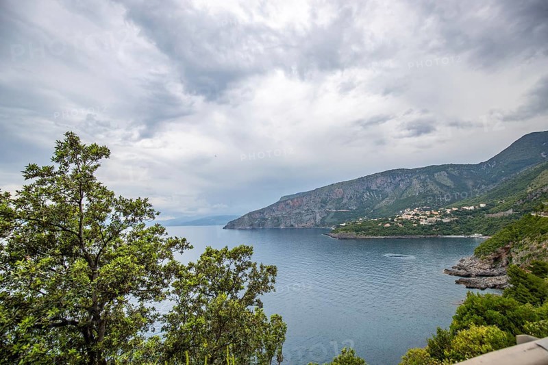 Coastal landscape shot. View from a road leading along the sea and through a breathtaking green Mediterranean landscape. Coast near Salerno, Italy, Europe