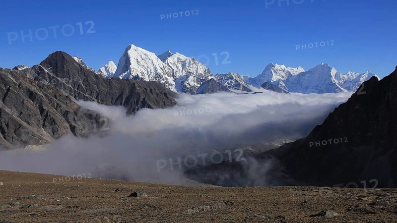 Sea of fog in the Gokyo Valley and snow capped high mountains of the Himalayas, Nepal, Asia