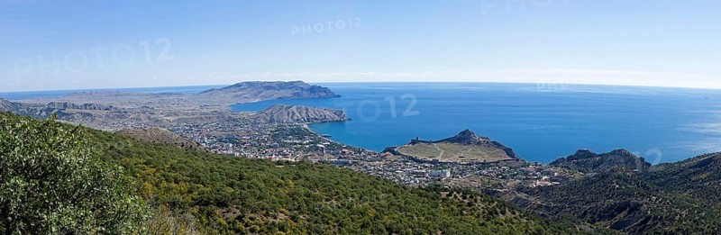 Panorama of the Black Sea coast, a view from the Perchem mountain on the resort town of Sudak and Kapselsky bay. Crimea. Sunny day in September