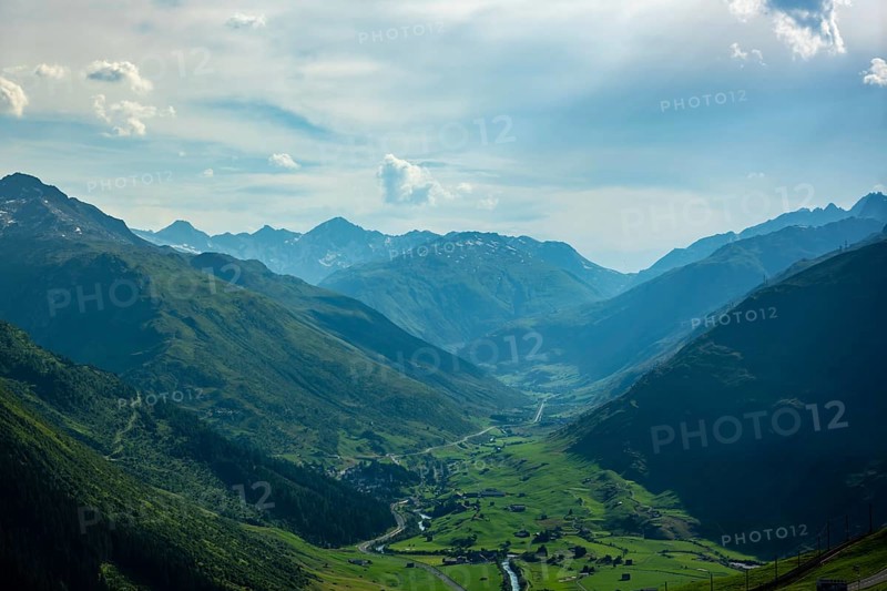 Beautiful Panoramic View over the Golf Course with Mountainscape and in a Mountain Valley in a Sunny Summer Day in Andermatt, Uri, Switzerland, Europe