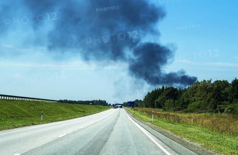 A big fire in the forest near the highway