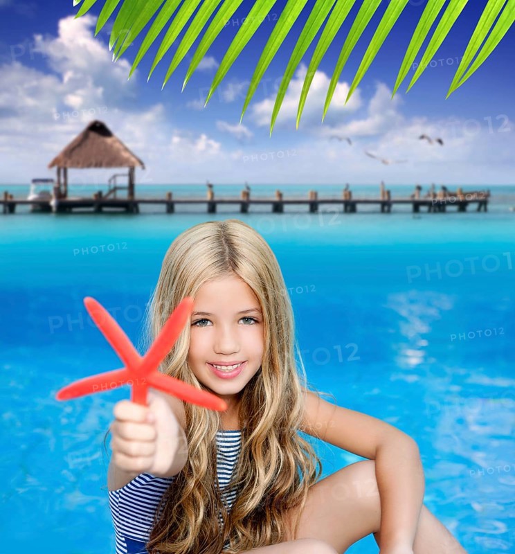 Children blond girl in summer vacation tropical beach with starfish