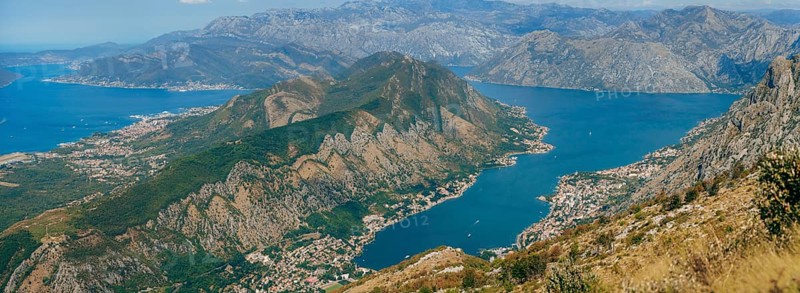Bay of Kotor from the heights. View from Mount Lovcen to the bay. View down from the observation platform on the mountain Lovcen. Mountains and bay in Montenegro. The liner near the old town of Kotor