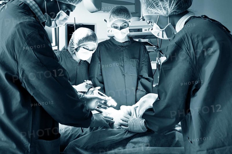Surgery team operating in a surgical room