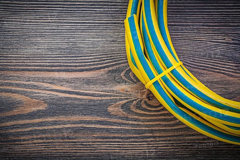 Coiled rubber hose on wooden board gardening concept