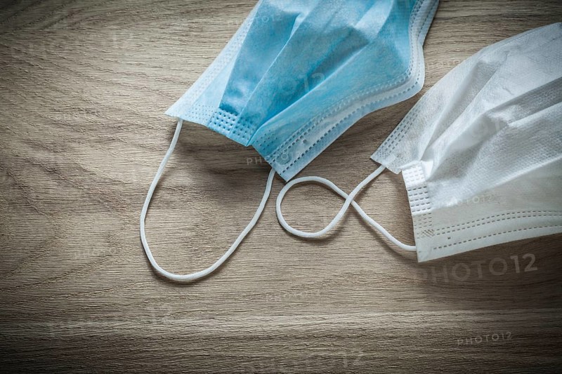 Disposable surgical mask on wooden board