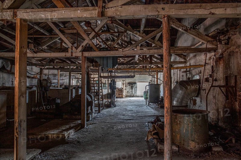 Old abandoned paper factory. Historic and typical factory building as a lost place. Destruction and decay are damaging the substance. Original machines and objects can be found here in Sweden