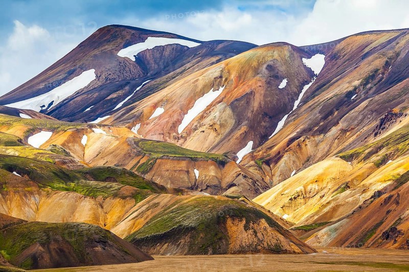 Valley National Park Landmannalaugar. On the gentle slopes of the mountains are snow fields and glaciers. Magnificent Iceland in the July