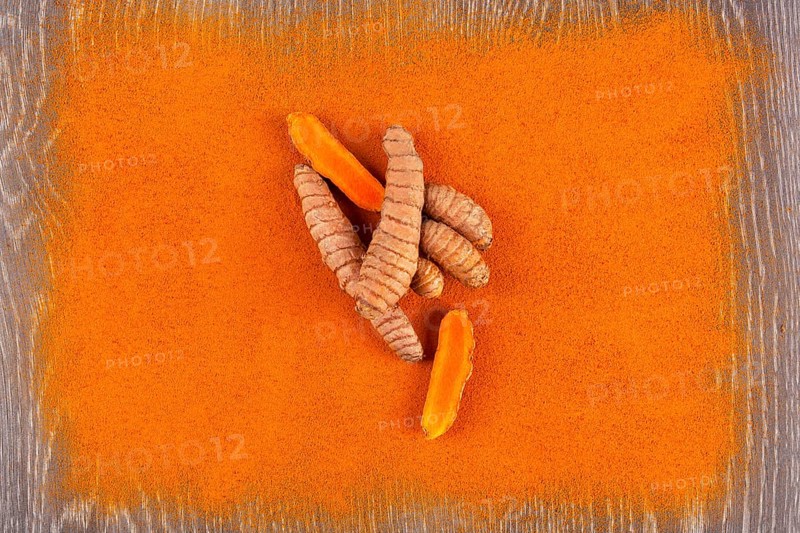Turmeric root and curcuma spice background. Anti-inflammatory herbal medicine, nutrional supplement