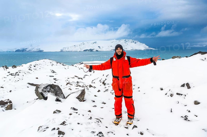 Man walks through ice and snow in Antarctica. Icebergs and everything frozen around you. Cold