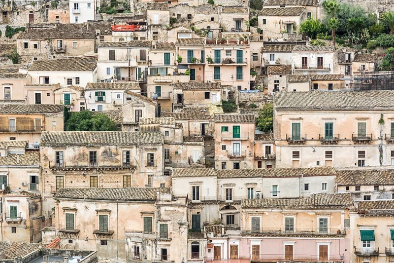 Typical ancient and picturesque town houses on a hill in Italy in the city of Modica on Sicily