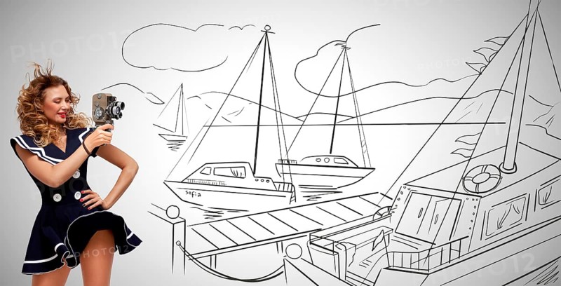 Glamorous pin up sailor girl in the harbour filming yachts with an old retro cinema 8 mm camera and standing in the wind, on grey sketchy background
