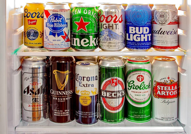 Calgary, Alberta, Canada. Jun 9 2020. Various beer cans of craft beers, domestic and imported beers from around the world on a mini fridge in a house cooler.Alcohol drinks background, different beer styles