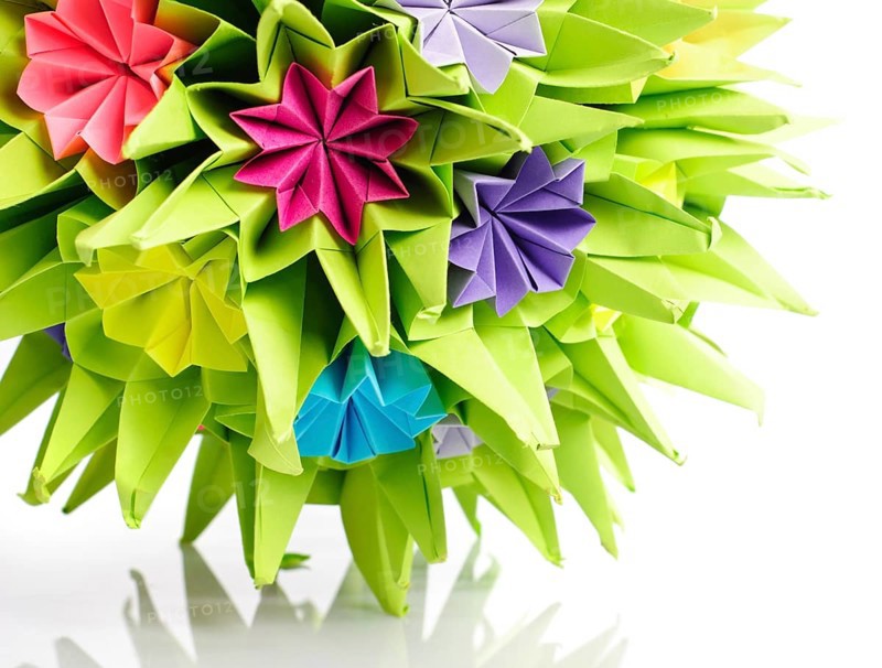 Colorfull origami kusudama from rainbow flowers isolated on white