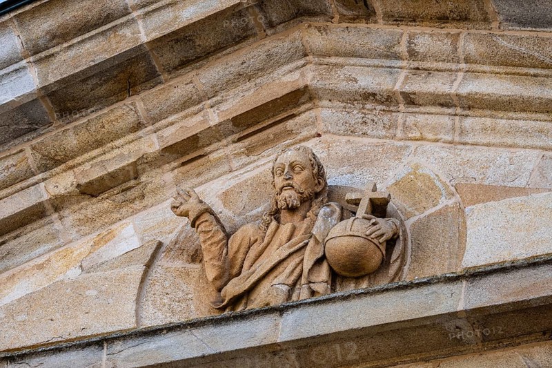 Detail of the pediment of the entrance portico of Zamora Cathedral with sculpture of Christ holding the sphere with a cross