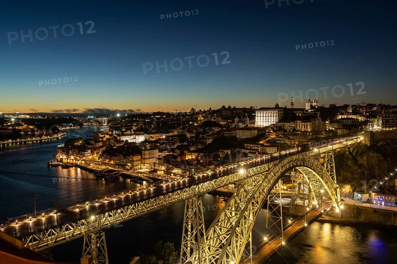 Illuminated Porto City, Douro River and Dom Luis bridge I at Night. View from Tourist Viewpoint Miradouro da Serra do Pilar. Portugal