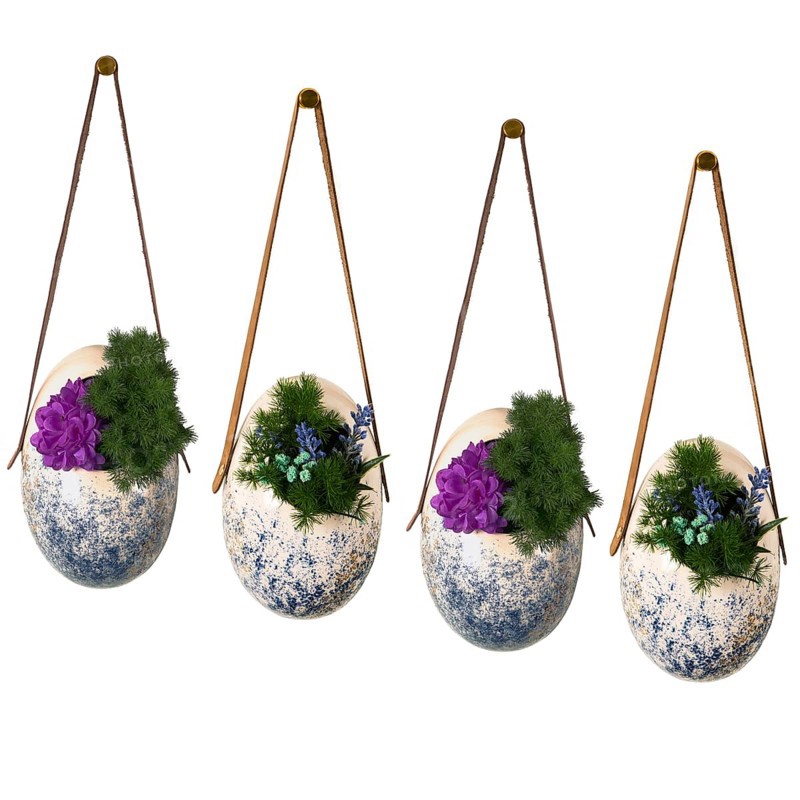 Four hanging planters with speckled design filled with flowers showcasing artistic decor