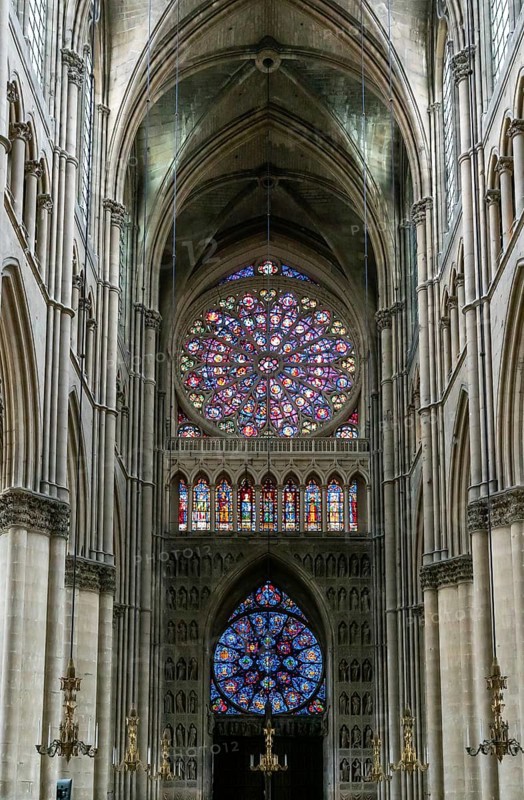 Reims, France- 13 September, 2022: view of the reverse side of the West Facade of the Reims Cathedral with colorful stained glass windows and sculptures