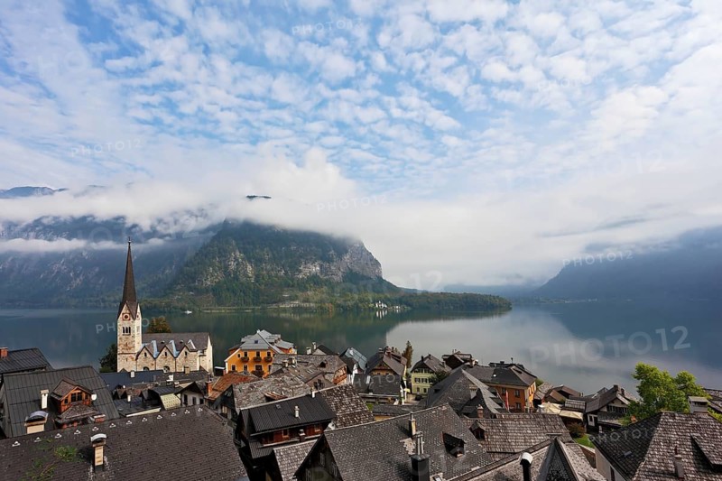 The most picturesque small town in Austria - Hallstatt. Slender bell tower and the church on the shore of Lake Hallstatt
