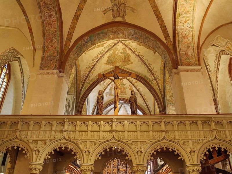 Church interior with an ornate altar and Christian figures under ornate frescoes and arches, holm, schleswig. germany