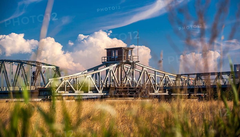 Rusty historic swing bridge with a small driver's cab on the roof