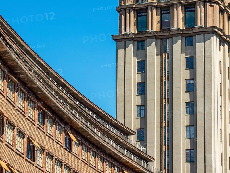 Modern building with a striking facade and a skyscraper in the background under a clear blue sky, stockholm, baltic sea, sweden, scandinavia