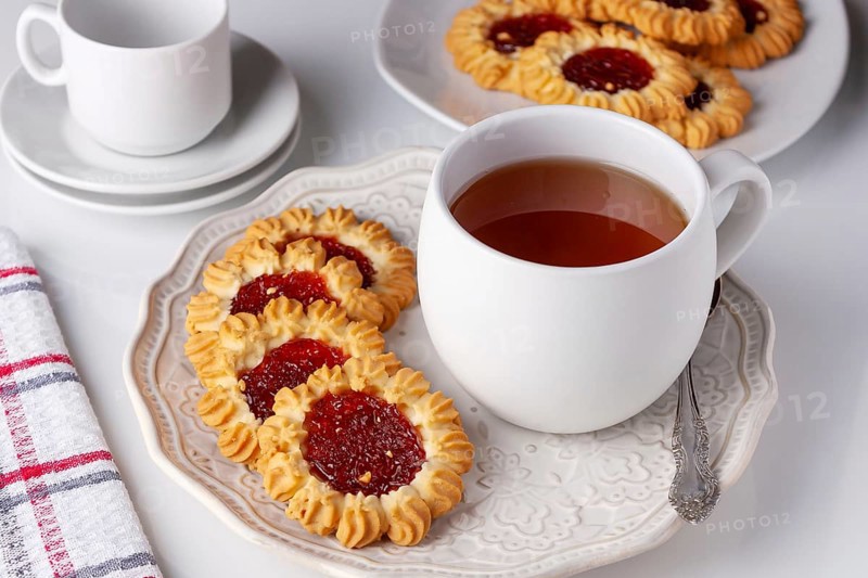 Cookies with jam and a cup of tea served for breakfast
