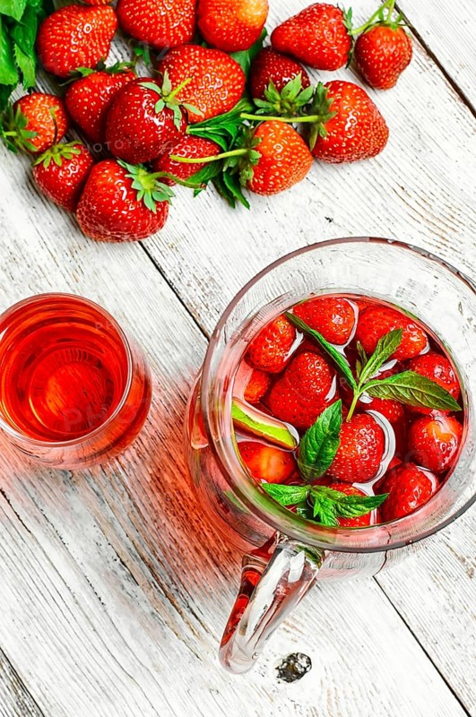 Glass decanter with delicious strawberry compote of fresh berries