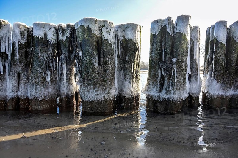 Iced groynes in early spring on the coast of the Baltic Sea in northern Germany, selected focus