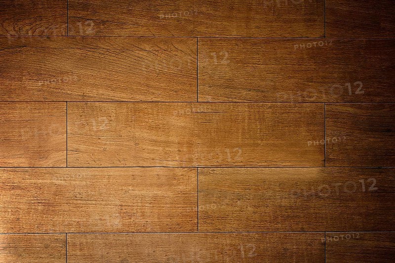 Warm light illuminating textured brown wooden floor tiles, creating a rustic and inviting ambiance.Belarus