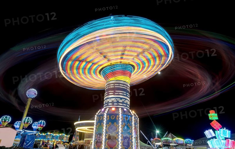 Merry go round, Carousel spinning fast creating wonderful light trails at an amusement park