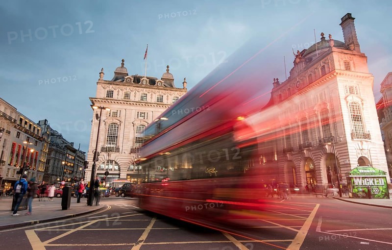 London, England, March 19, 2018: Night scene from the famous London Piccadilly circus square at the centre of London with cars and buses leaving colorful light traces