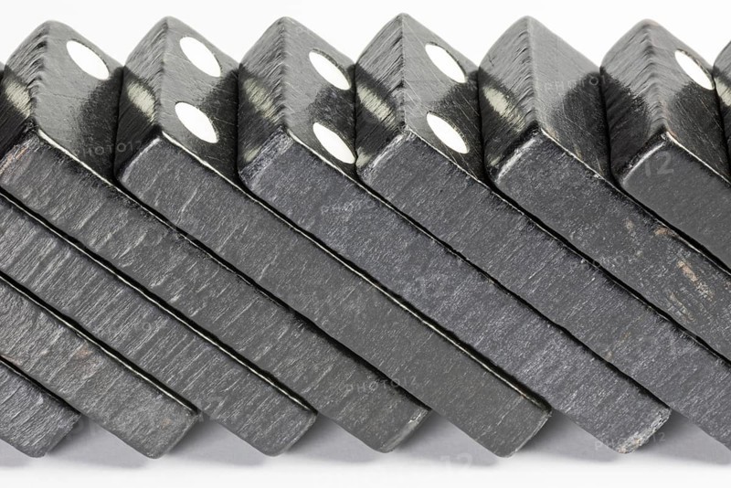 Composition of lying black domino bricks with white dots