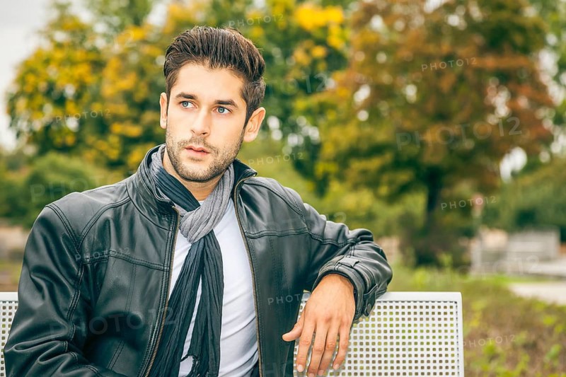 An image of a young man with a black leather jacket