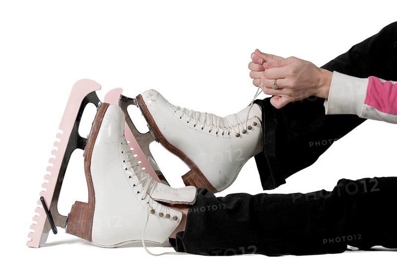 Beautiful young woman figure skater on ice skates