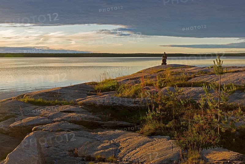 Evening on the White Sea. Stone pillar on coastal granite rock. Kandalaksha Gulf, Karelia, Russia, end of June, Europe
